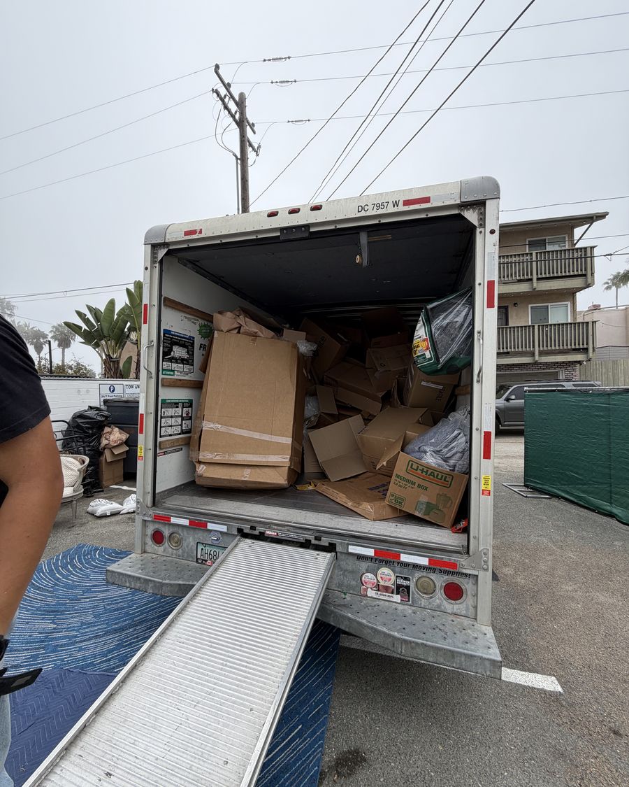 Truck loaded with flattened cardboard boxes after a move-out
